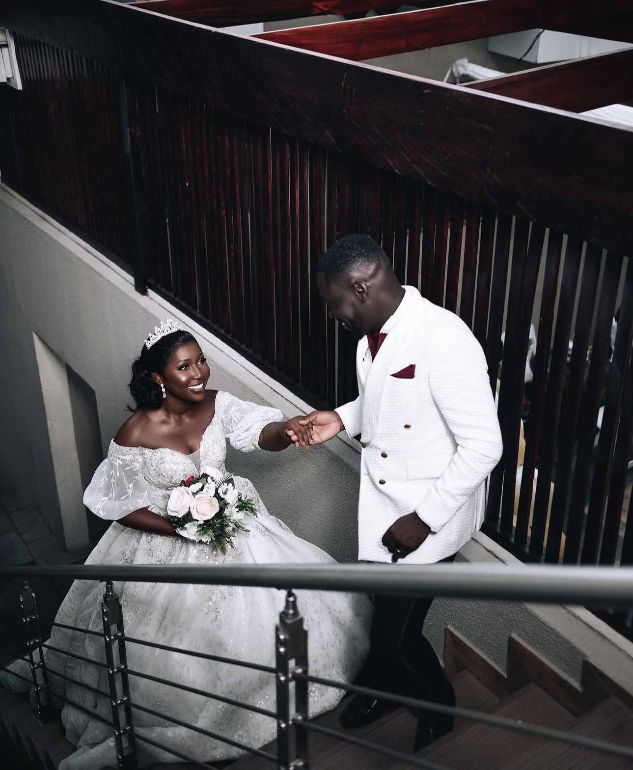 Vivace white wedding collection — bride and groom on staircase, Crimson Concepts, Accra Ghana